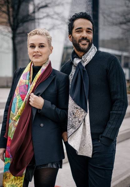 A couple wearing vibrant scarves, adding a pop of color to their outfits.